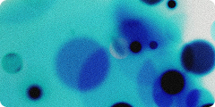 Abstract image showing various shades of blue circular shapes and gradients on a light background, resembling ink or watercolor spots.
